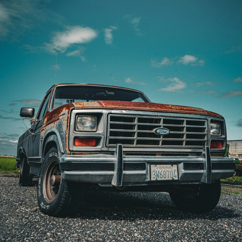 Ford Super Duty parked on a gravel worksite at dawn.